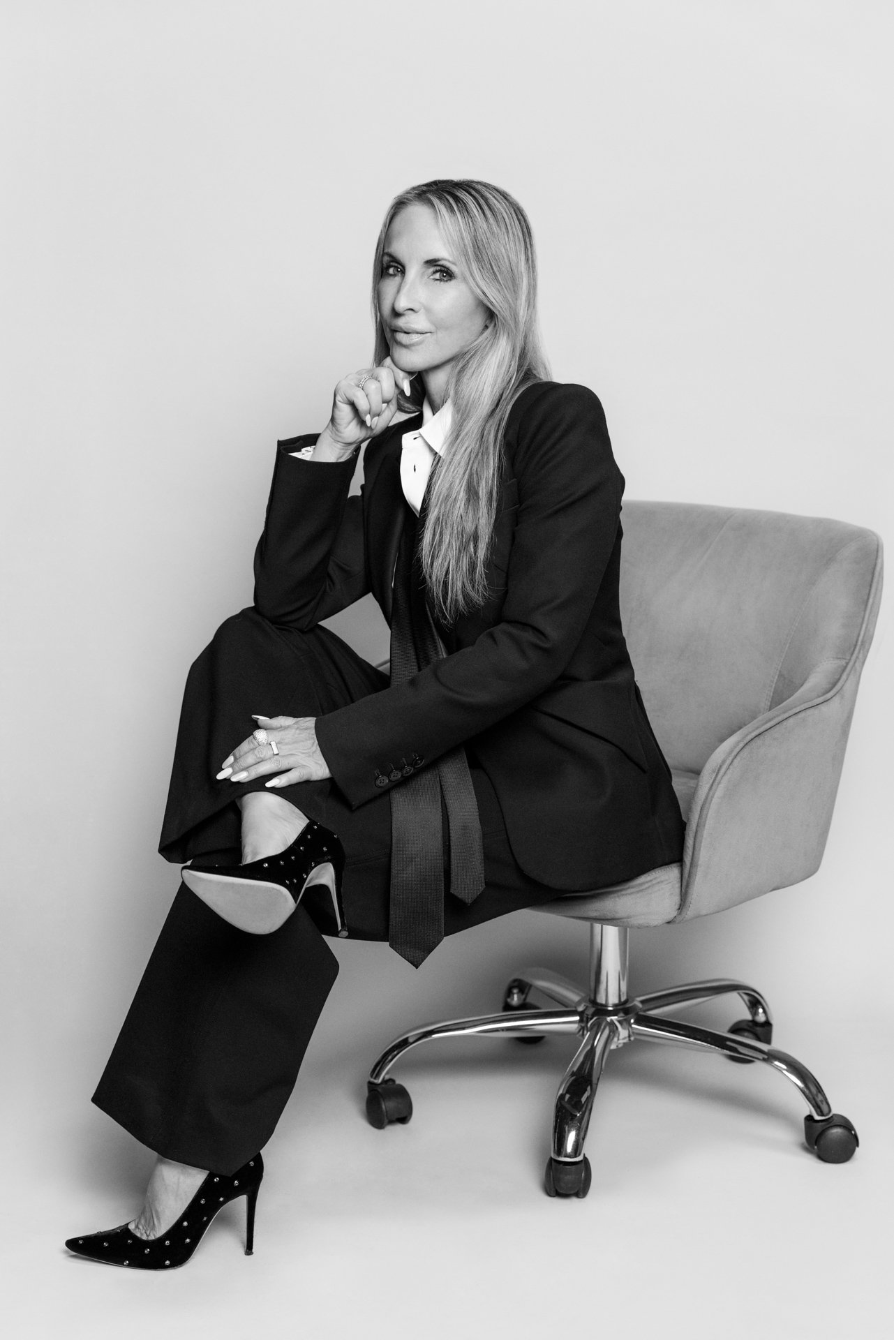 Business woman in black suit seated black and white editorial portrait san diego studio headshots by Siobhan Gazur Photography