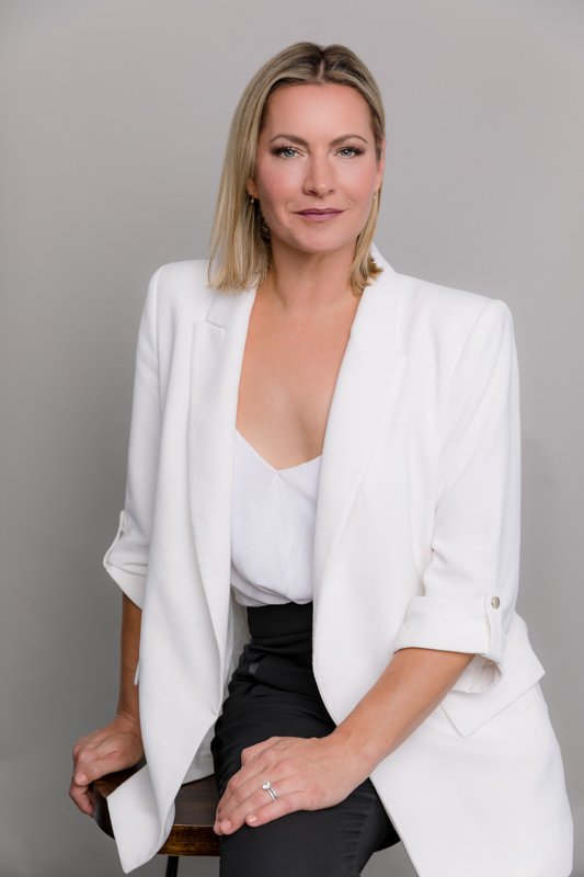 Business woman in white blazer seated studio portrait san diego studio headshots by Siobhan Gazur Photography