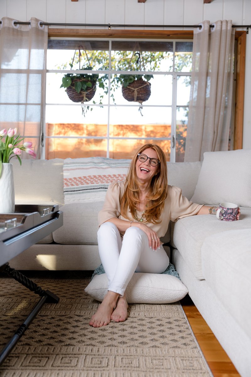Writer seated in a living room during a personal branding photography session san diego by Siobhan Gazur Photography