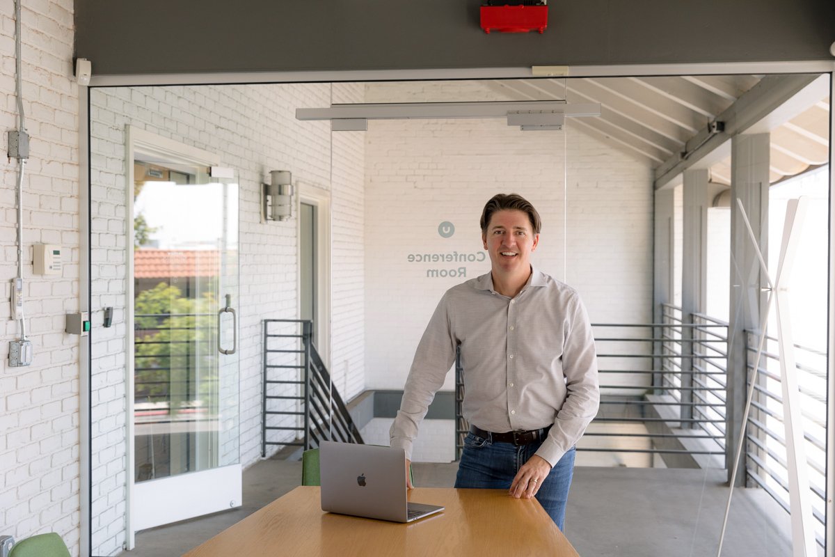 Leadership coach working at a laptop during personal branding photography san diego by Siobhan Gazur Photography