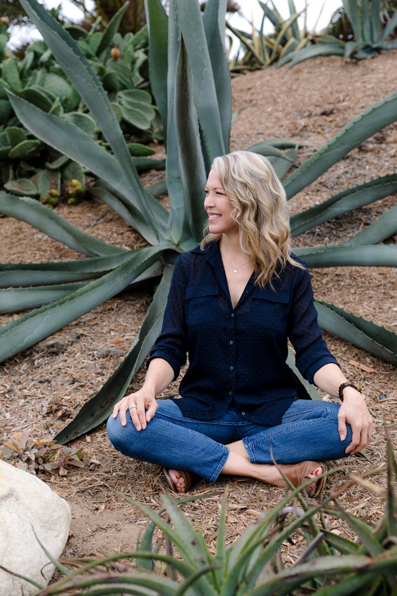 Lifestyle personal branding portrait of an educator seated outdoors near agave plants san diego branding photography by Siobhan Gazur Photography